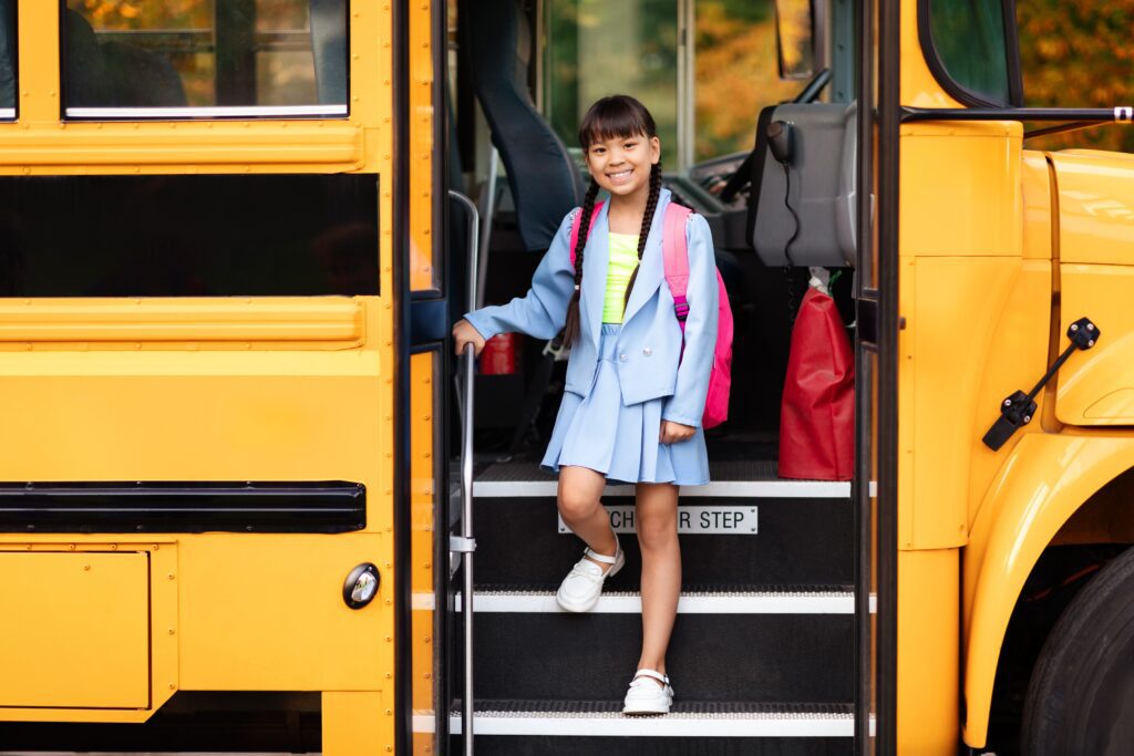girl Getting Of The Yellow Bus