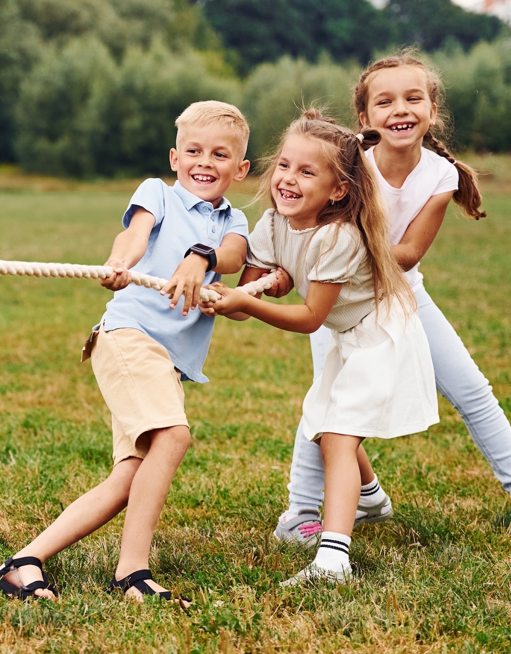 Kids playing a game of tug-of-ware to prepare their bodies for the school year.