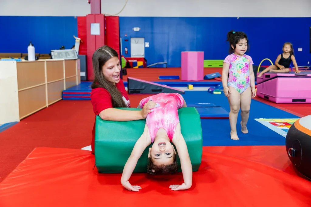 Coach training young gymnasts