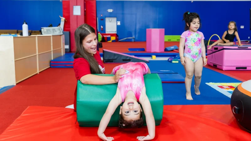 Coach training young gymnasts