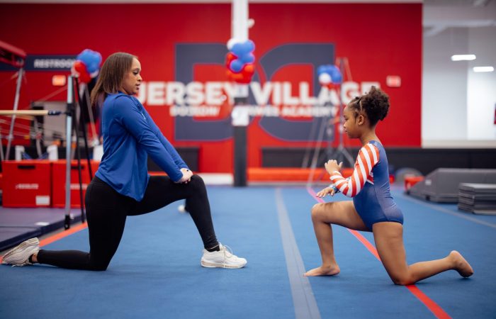 DDGNA Gymnastics coach teaching a child in Houston, TX