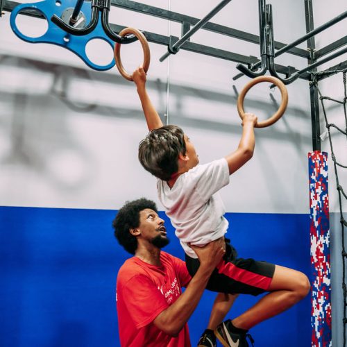 boy on the gym rings