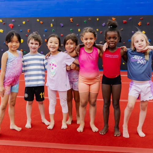 Group of kids having fun in class at Dominique Dawes Academy