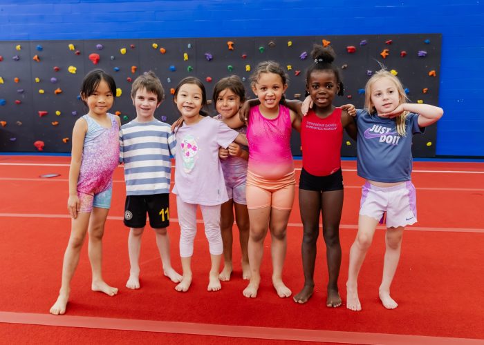 Group of kids having fun in class at Dominique Dawes Academy